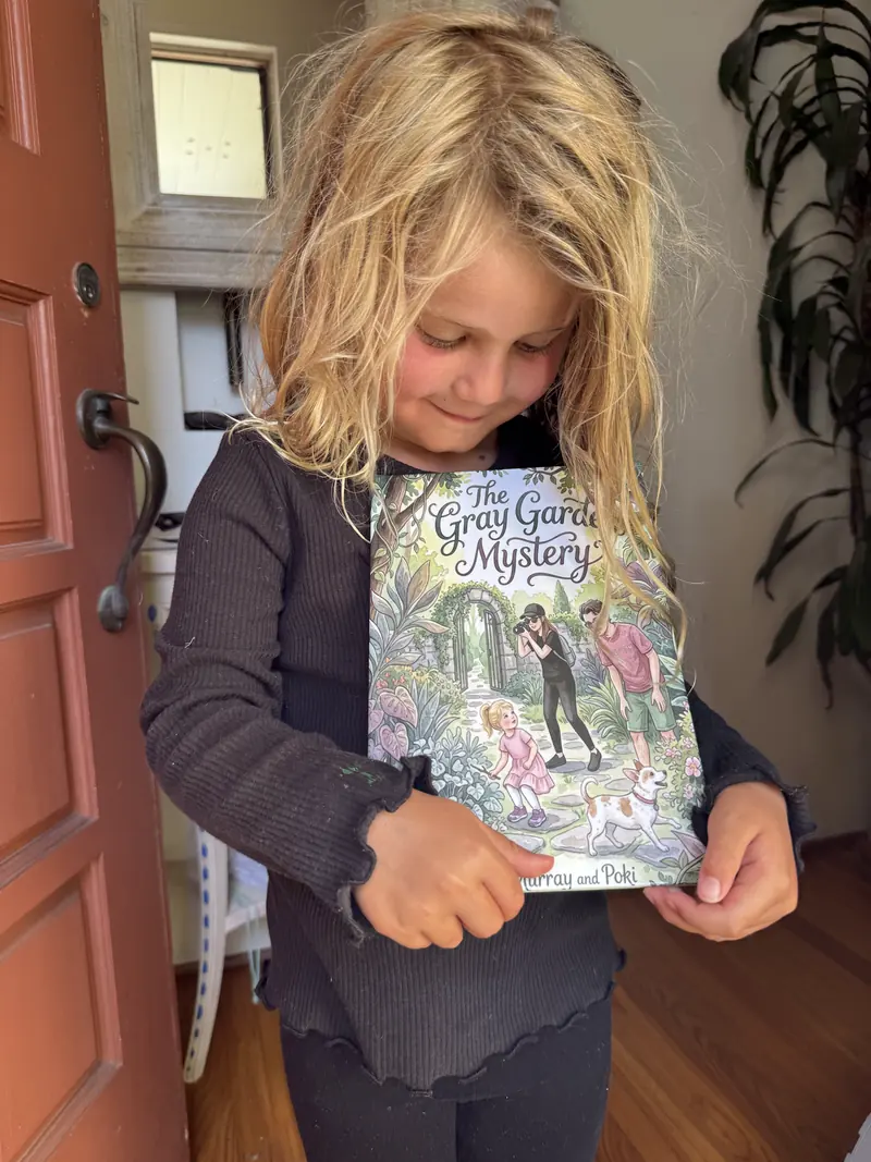 Murray holding her printed copy of The Gray Garden Mystery