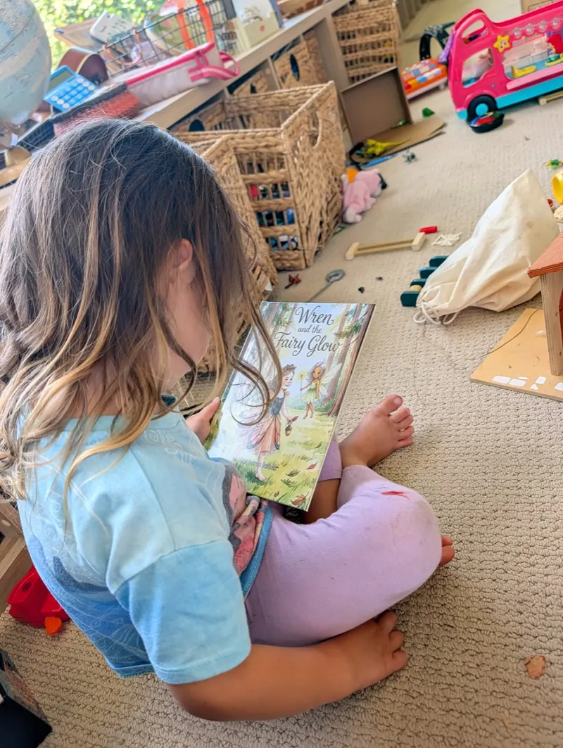 Child reading a printed StorySafari book